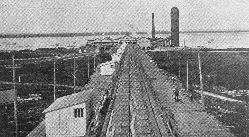 A long lumber conveyor over the river at Arnprior in 1921